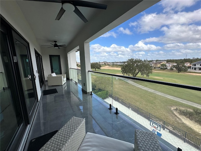 balcony featuring ceiling fan and an outdoor living space