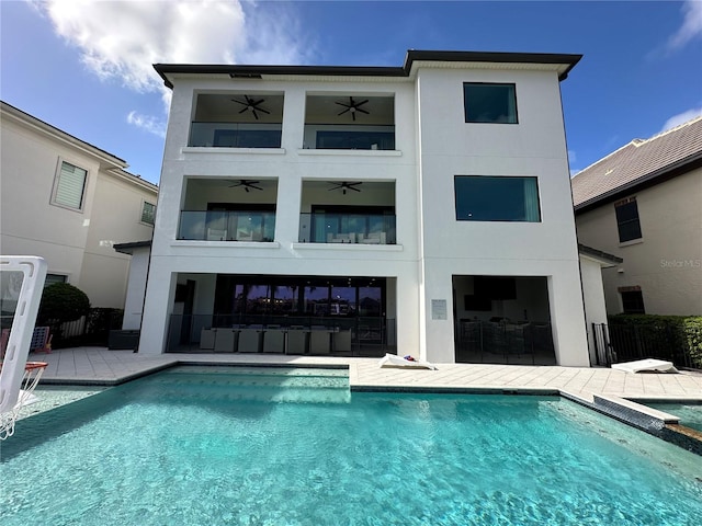 rear view of property with a patio area and ceiling fan