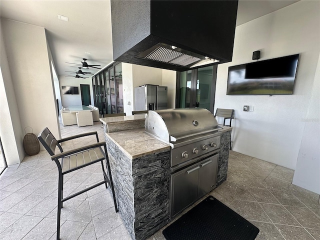 view of patio / terrace featuring area for grilling, ceiling fan, and a grill