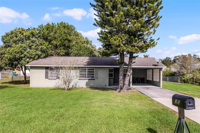 ranch-style home featuring a carport and a front lawn