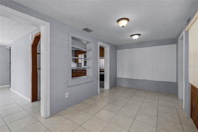 tiled spare room with built in shelves