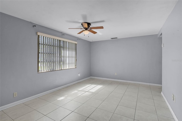 tiled empty room with ceiling fan