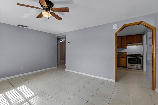 tiled spare room featuring ceiling fan