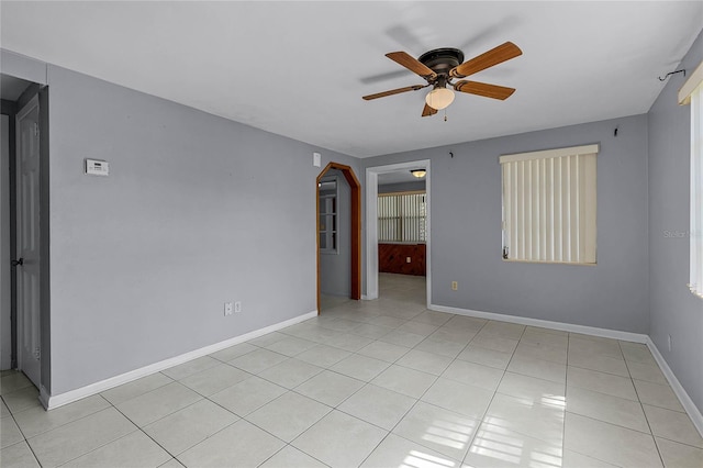 unfurnished room featuring light tile patterned floors and ceiling fan