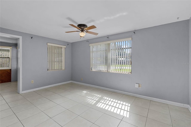 spare room featuring light tile patterned flooring and ceiling fan