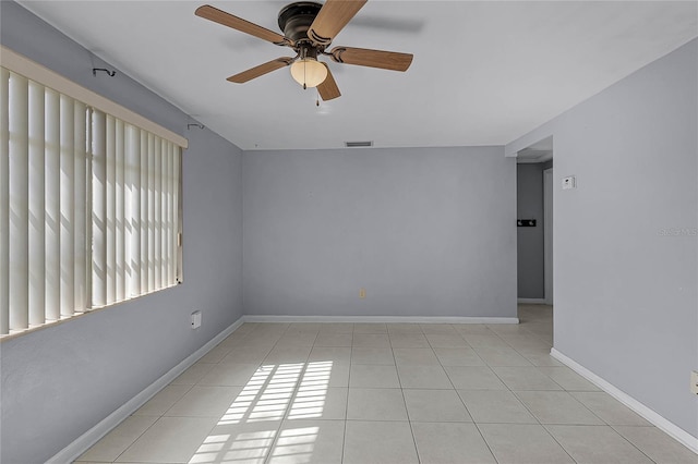 spare room featuring light tile patterned floors and ceiling fan