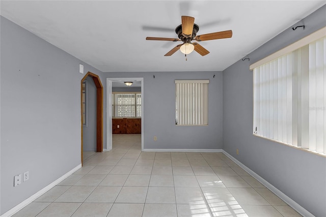 tiled empty room with ceiling fan