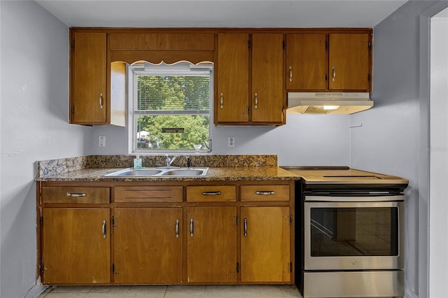 kitchen with light tile patterned floors, sink, and stainless steel range with electric cooktop