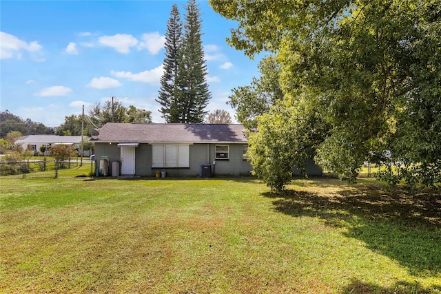 rear view of property featuring a yard