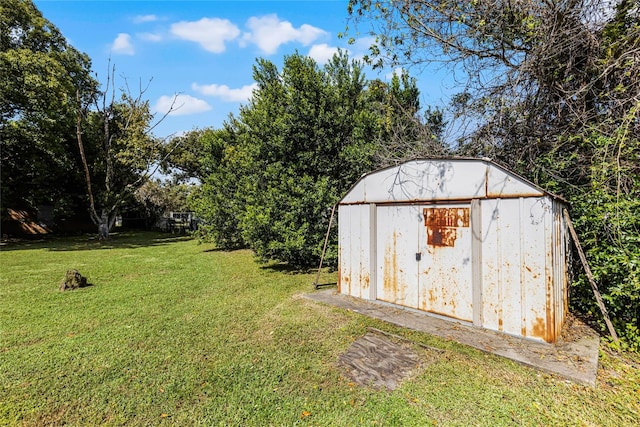 view of outbuilding with a lawn