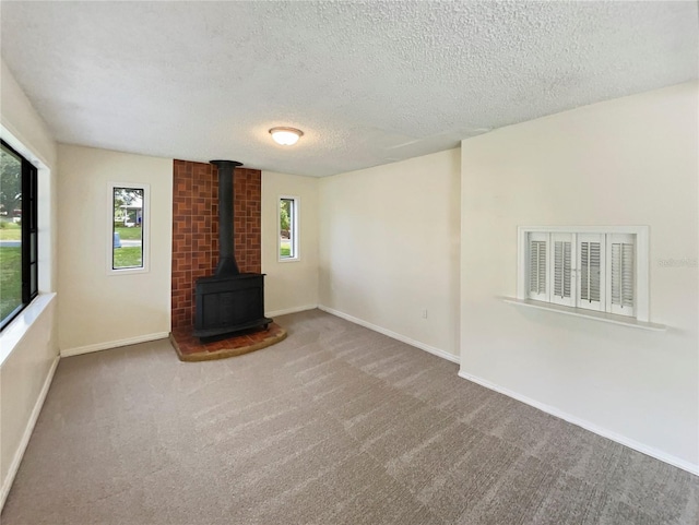 unfurnished living room with carpet flooring and a textured ceiling