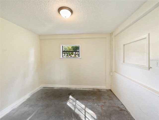 spare room featuring a textured ceiling