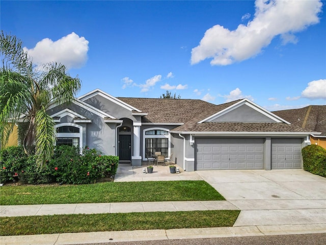 ranch-style house with a front lawn and a garage