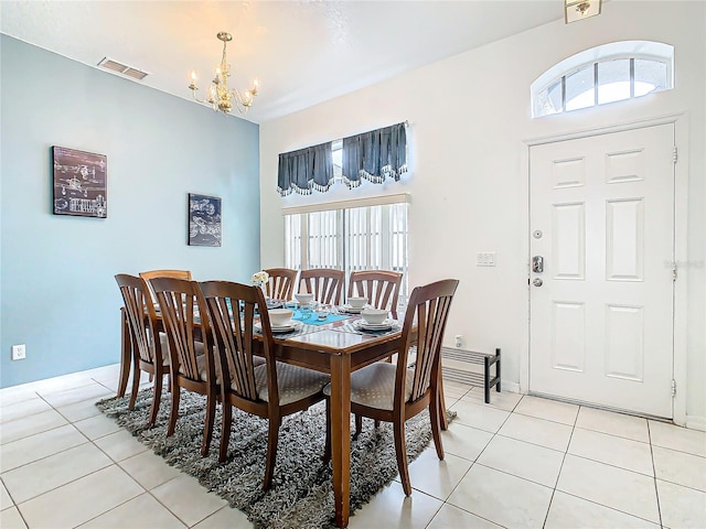 dining room featuring light tile patterned floors and a chandelier