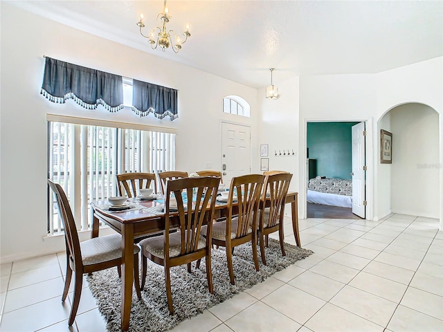 dining space featuring light tile patterned floors and an inviting chandelier