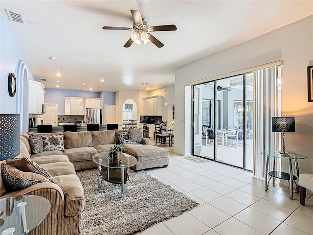 tiled living room with ceiling fan