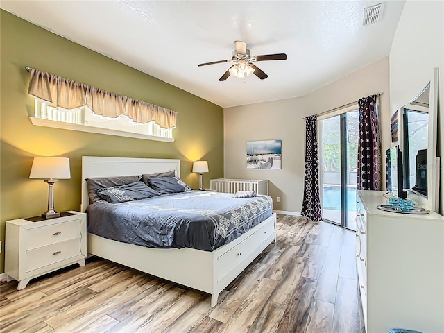 bedroom with ceiling fan, access to exterior, light hardwood / wood-style floors, and radiator