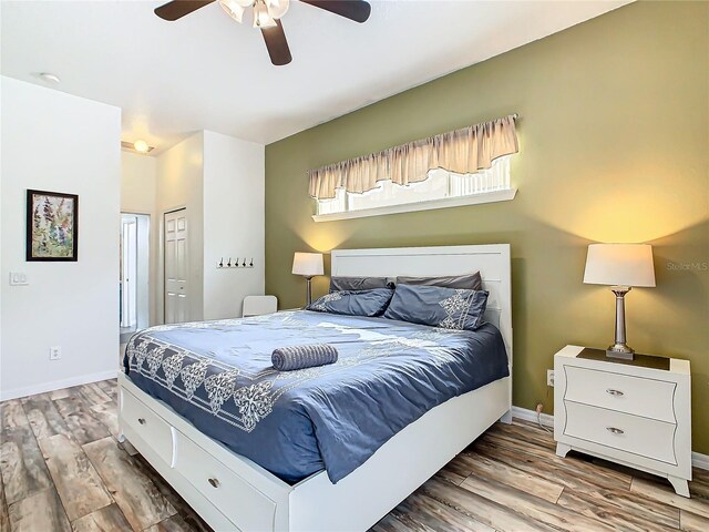 bedroom featuring a closet, hardwood / wood-style flooring, and ceiling fan