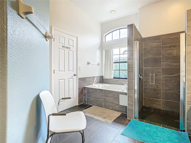 bathroom with tile patterned floors and plus walk in shower