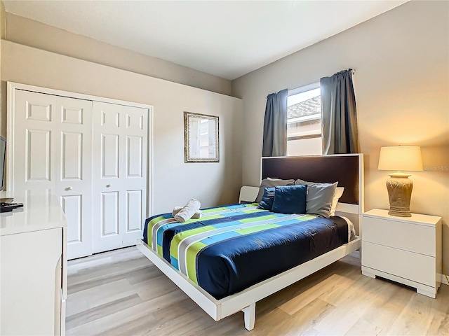 bedroom featuring a closet and light wood-type flooring