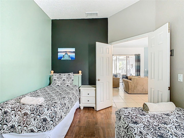 bedroom featuring a textured ceiling and light wood-type flooring