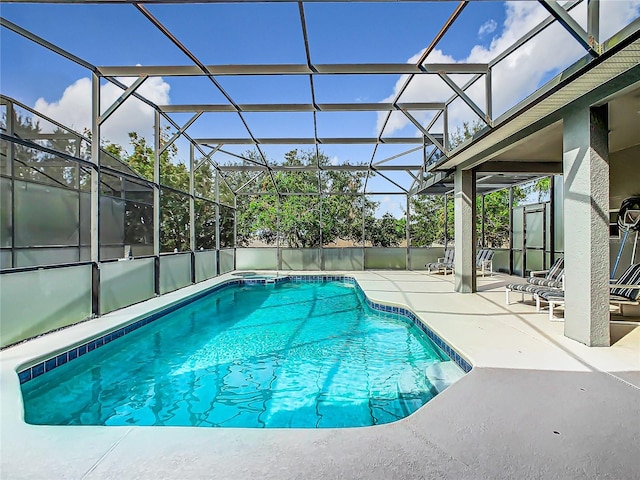 view of swimming pool featuring a patio area and glass enclosure