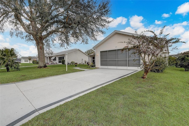 view of front of property featuring a front yard and a garage