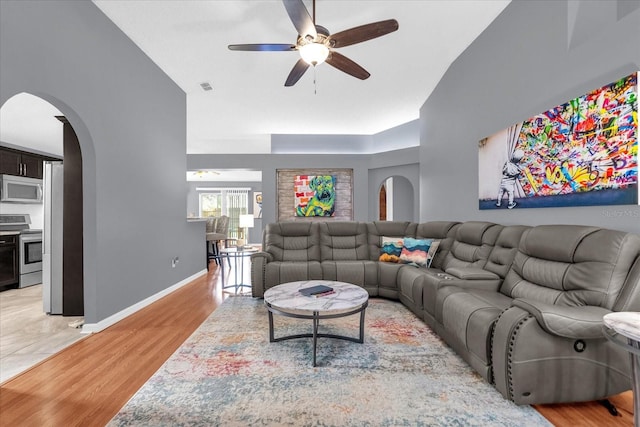 living room with light hardwood / wood-style floors and ceiling fan