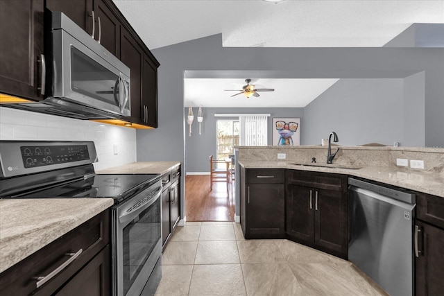 kitchen featuring tasteful backsplash, sink, stainless steel appliances, lofted ceiling, and light hardwood / wood-style flooring