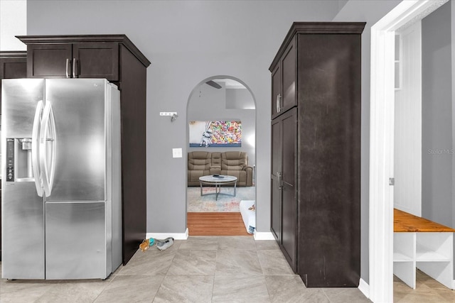 kitchen featuring dark brown cabinets and stainless steel refrigerator with ice dispenser