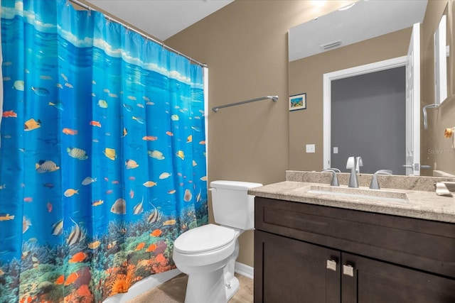 bathroom featuring vanity, toilet, and curtained shower