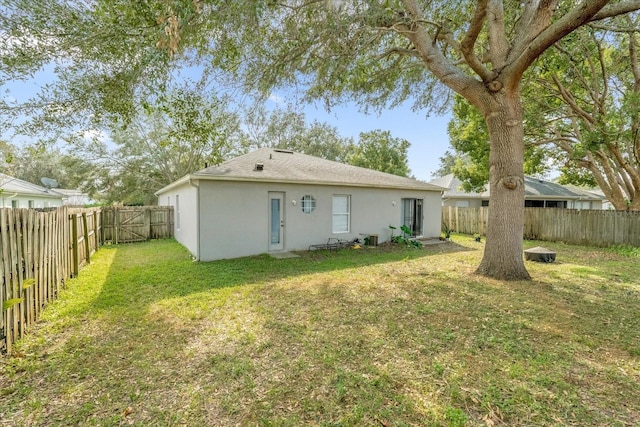 rear view of property with a lawn