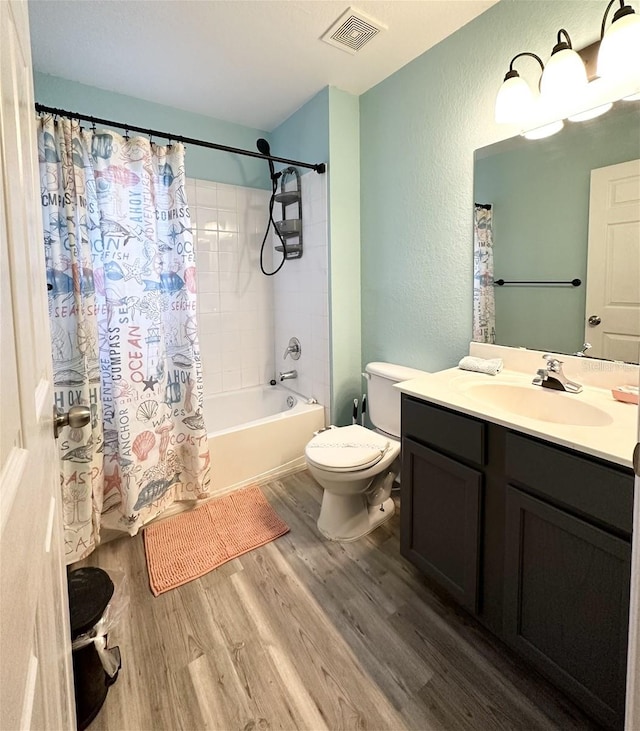 full bathroom featuring vanity, shower / bath combo with shower curtain, wood-type flooring, and toilet