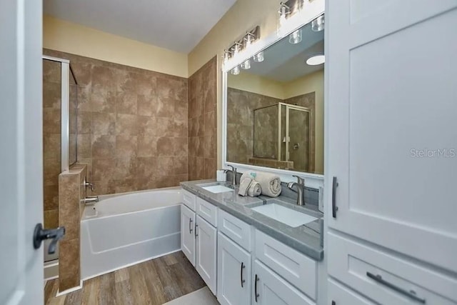 bathroom featuring vanity, independent shower and bath, and hardwood / wood-style flooring