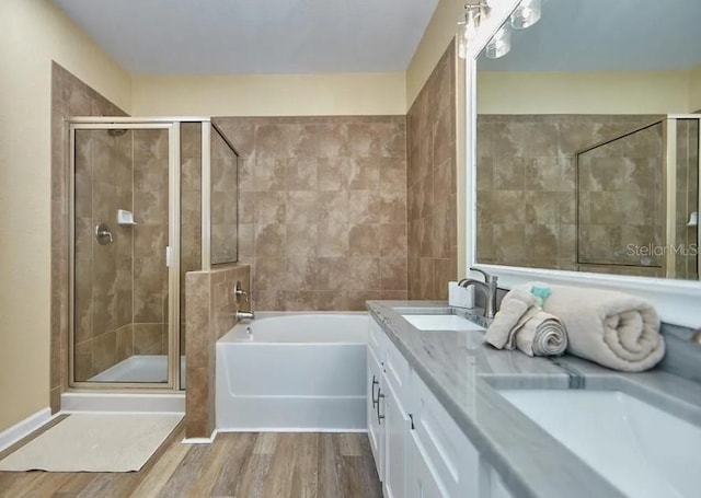 bathroom with vanity, independent shower and bath, and hardwood / wood-style flooring