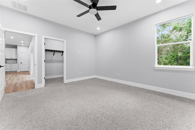 unfurnished bedroom featuring carpet, a closet, and ceiling fan