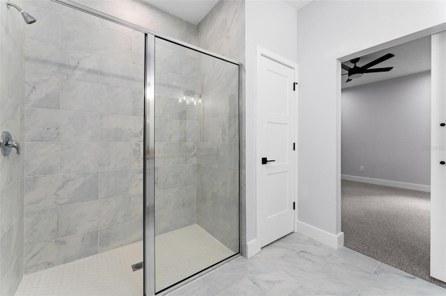 bathroom with a shower with door and ceiling fan