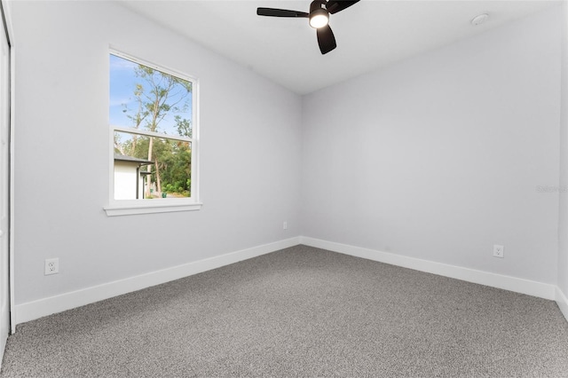 carpeted spare room featuring ceiling fan