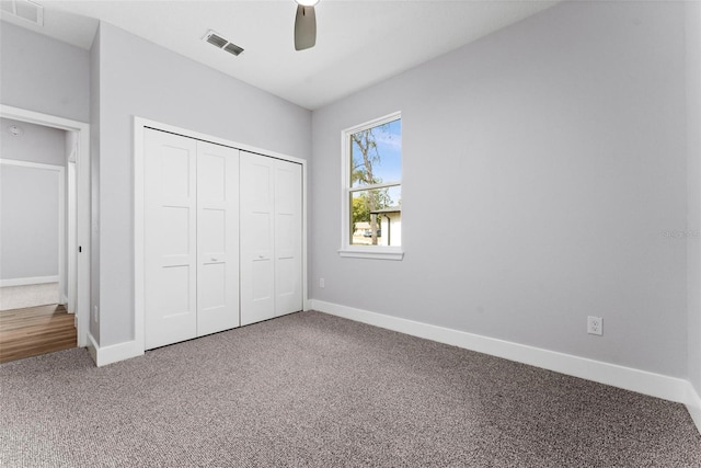 unfurnished bedroom featuring a closet, ceiling fan, and carpet flooring