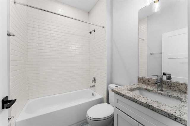 full bathroom with toilet, tiled shower / bath combo, and vanity