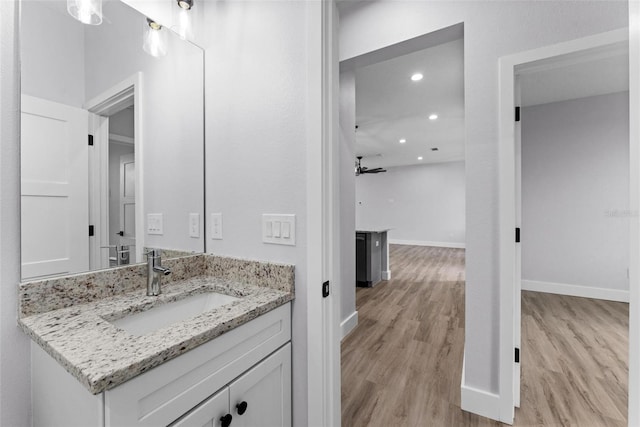 bathroom with vanity, ceiling fan, and wood-type flooring