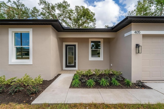 view of exterior entry featuring a garage