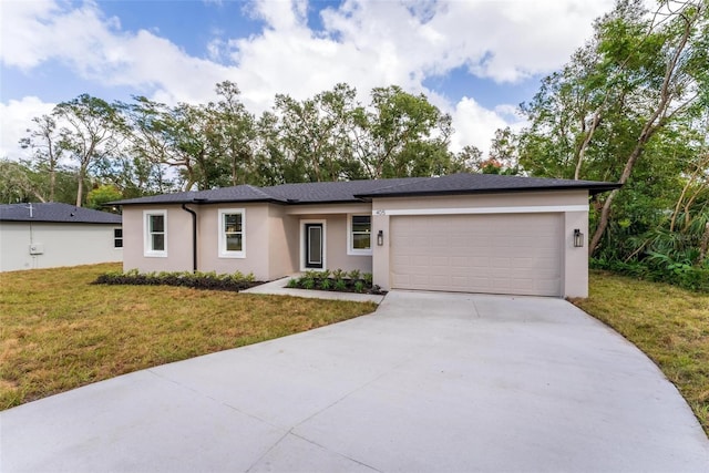 view of front of property with a front lawn and a garage