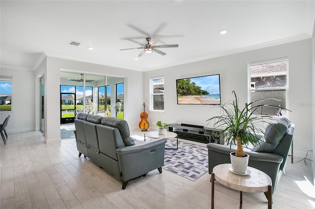 living room with ornamental molding, light hardwood / wood-style flooring, and ceiling fan