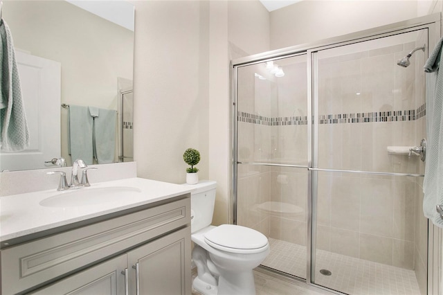 bathroom featuring vanity, toilet, hardwood / wood-style flooring, and a shower with door