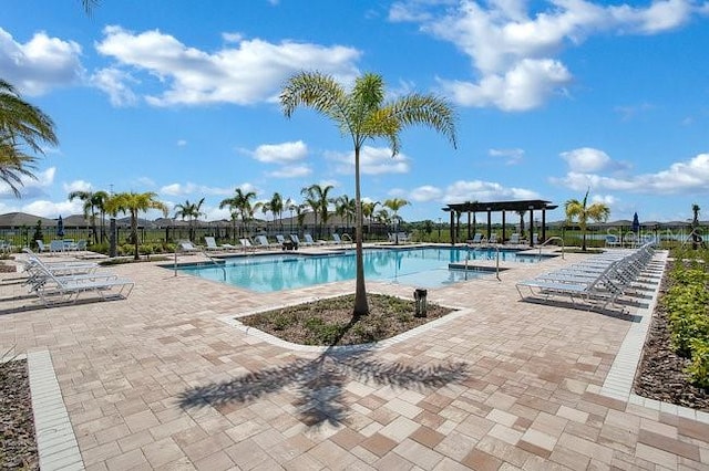 view of swimming pool with a patio area and a pergola