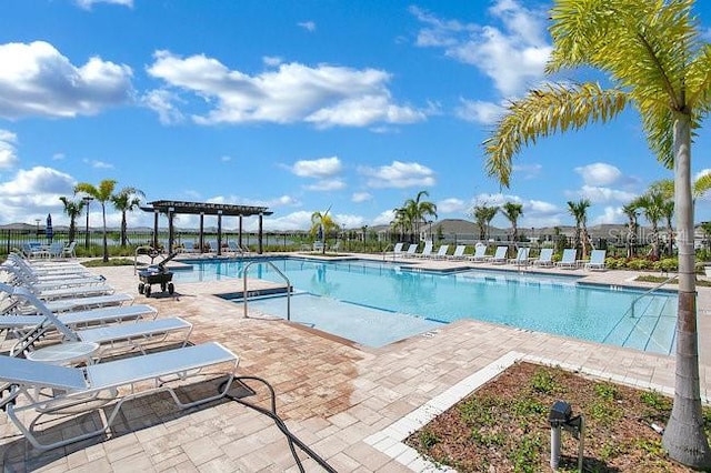 view of swimming pool featuring a patio area and a pergola