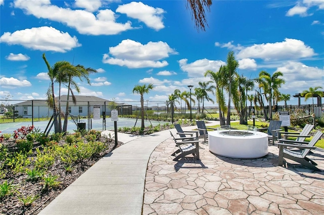 view of community with a patio and a fire pit