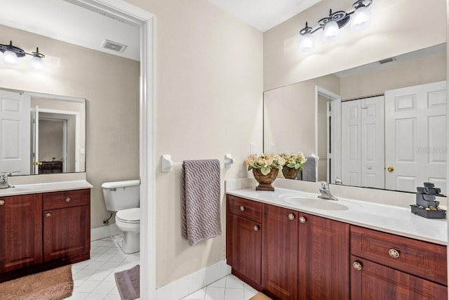 bathroom with vanity, toilet, and tile patterned floors