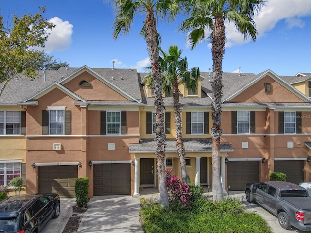 multi unit property featuring a garage